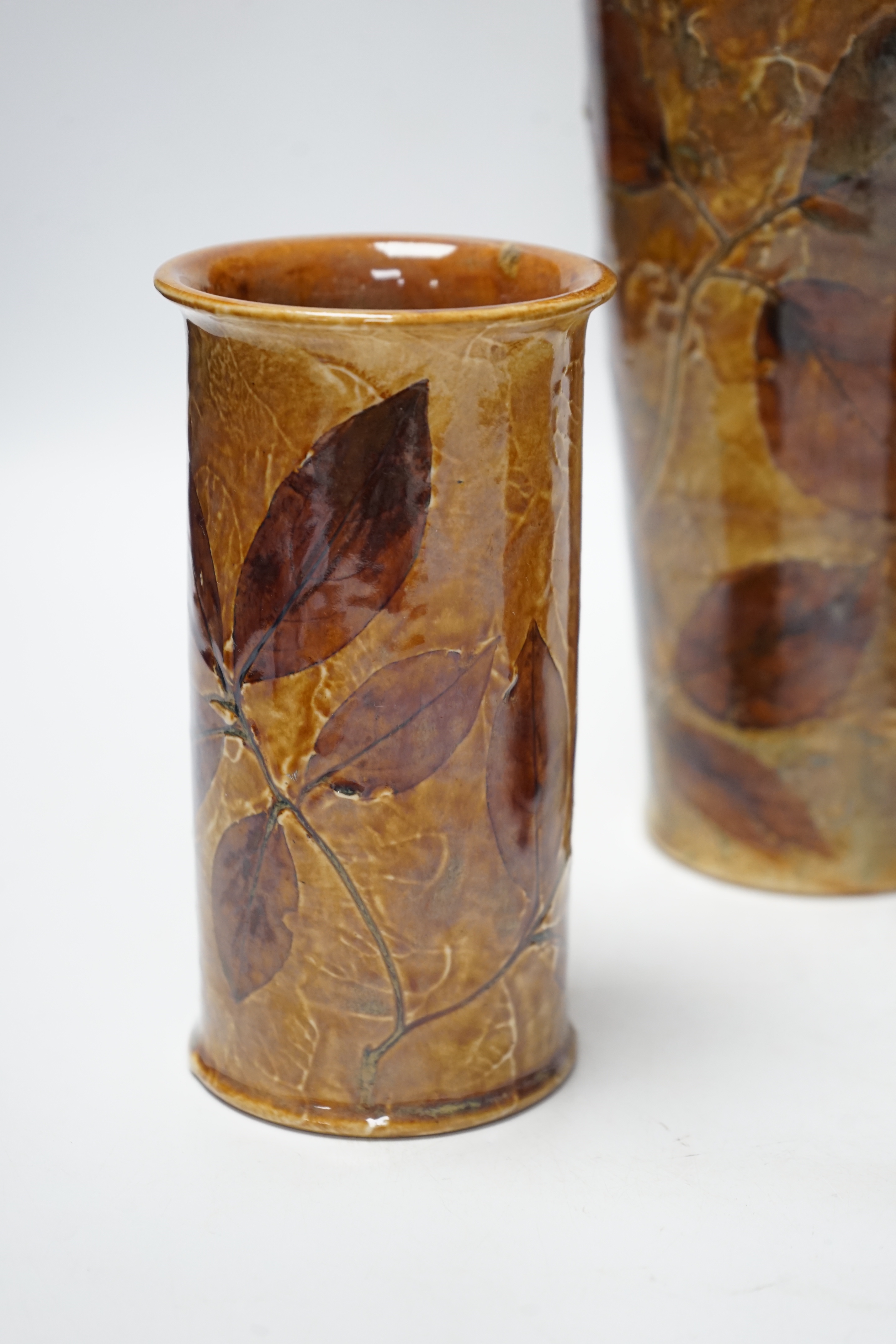 Two Doulton natural foliage ware vases and a jug, 25cm